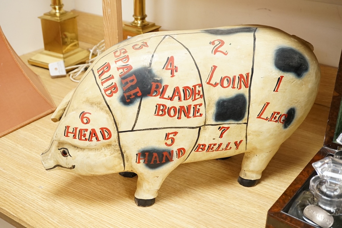 A painted wood butcher’s pig display model, inscribed Hutton’s for Pork and with examples of various cuts of meat to one side, 58cm wide